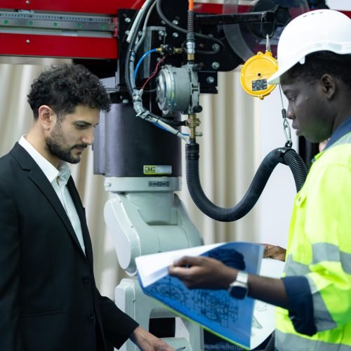 technicians-are-introducing-industrial-hand-robots-businessperson-factory-industry-min